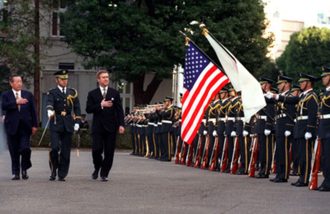 Secretary of Defense William Cohen (right) is welcomed to the Japan Defense Agency in Tokyo, Japan, with a full honors military arrival ceremony hosted by Hosei Norota (left), the agency's director general, on Jan. 13, 1999. Cohen will meet with Norota to discuss a range of security issues, both regional and global, of mutual interest to both nations. Cohen is visiting Tokyo as part of a five-day trip to Japan and the Republic of Korea. 