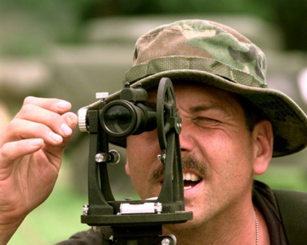 Master Sgt. Greg Bacon shoots a level line for the floor of a large general purpose tent to be erected at a U.S. military base camp being built near El Progreso, Honduras, on Jan, 19, 1999. Bacon is a U.S. Air Force reservist attached to the 452nd Civil Engineer Squadron, March Air Reserve Base, Calif. The engineers are deployed as part of a joint service, civil engineering project tasked with building the 480 bed base camp for U.S. military units participating in the humanitarian Exercise New Horizon 99. The joint task force is comprised of service members from the U.S. Air Force Reserve, Air National Guard, U.S. Army and Army National Guard. 