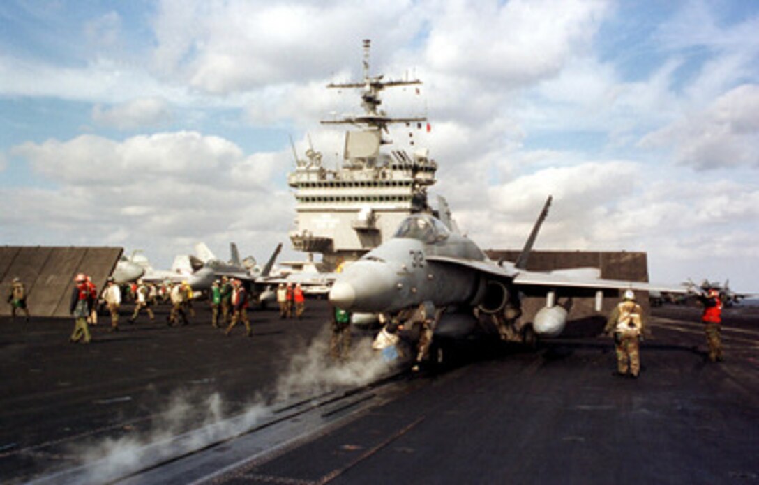 An F/A-18C Hornet is readied for launch as it sits on catapult number two on the flight deck of the aircraft carrier USS Enterprise (CVN 65) during flight operations in the Ionian Sea on Feb. 9, 1999. Enterprise and its embarked Carrier Air Wing 3 are forward deployed to the Mediterranean Sea. 