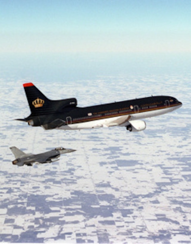 A Minnesota Air National Guard F-16A Fighting Falcon escorts Royal Jordanian 1, the aircraft of His Majesty King Hussein I, of the Hashemite Kingdom of Jordan, as it flies over Minnesota on its return to Amman, Jordan on Feb. 4, 1999. The Fighting Falcon is attached to the 148th Fighter Wing, Air National Guard, Duluth, Minn. 