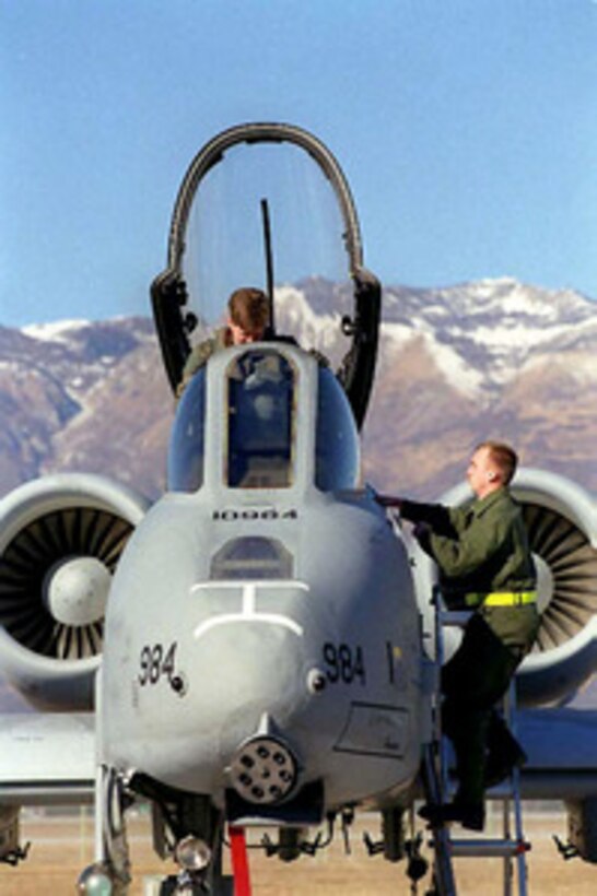 Crew Chief Airman 1st Class Steven Jenkins (right), U.S. Air Force, watches as Capt. John O'Brien (left) settles into the cockpit of his A-10 Thunderbolt II at Aviano Air Base, Italy, in preparation for an Operation Deliberate Forge mission over Bosnia and Herzegovina on Feb. 5, 1999. The A-10, more commonly known as a Warthog, and its crew are attached to the 81st Fighter Wing from Spangdahlem Air Base, Germany. Deliberate Forge is the air support of Operation Joint Forge. 