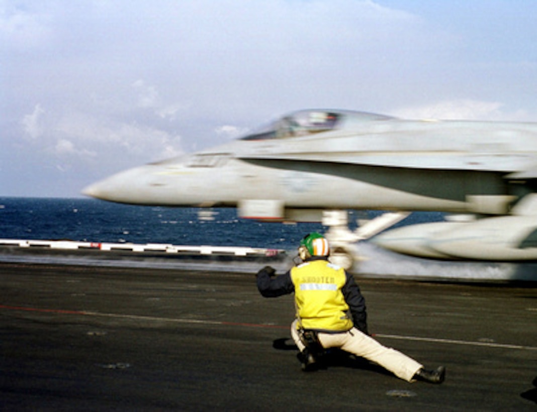 An F/A-18 Hornet hurtles down the catapult of the USS Enterprise.