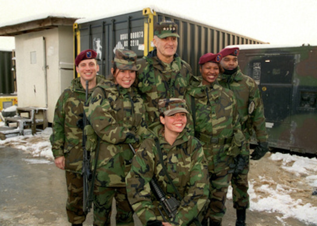 Gen. Henry H. Shelton, chairman of the Joint Chiefs of Staff, poses for photographs with soldiers at Comanche Base, Bosnia and Herzegovina, on Dec. 22, 1998. Shelton is visiting with troops deployed to Bosnia and Herzegovina in support of Operation Joint Forge. 
