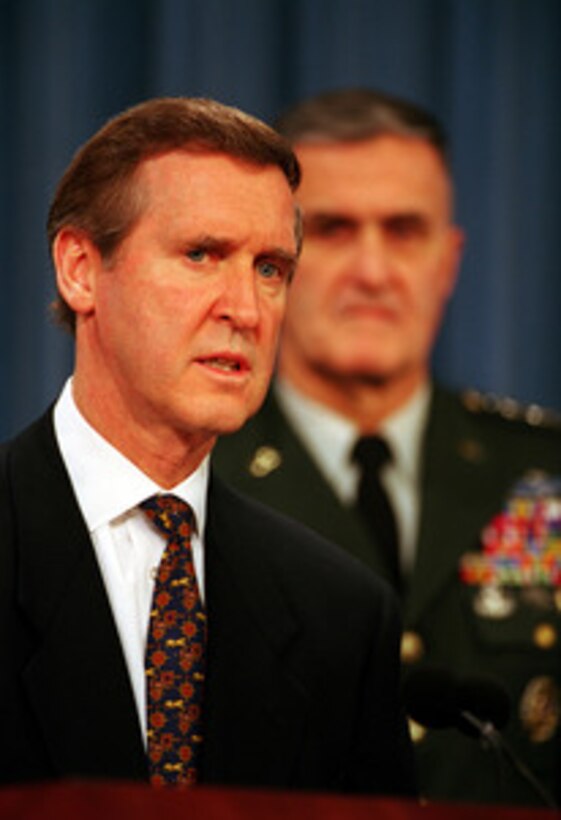 Secretary of Defense William S. Cohen (left) and Gen. Henry H. Shelton (right), U.S. Army, chairman of the Joint Chiefs of Staff, announce a package of pay raises and retirement benefit improvements for members of the U.S. armed services during a Dec. 21, 1998, Pentagon press conference. The pay package will be included in President Clinton's Fiscal Year 2000 budget. 