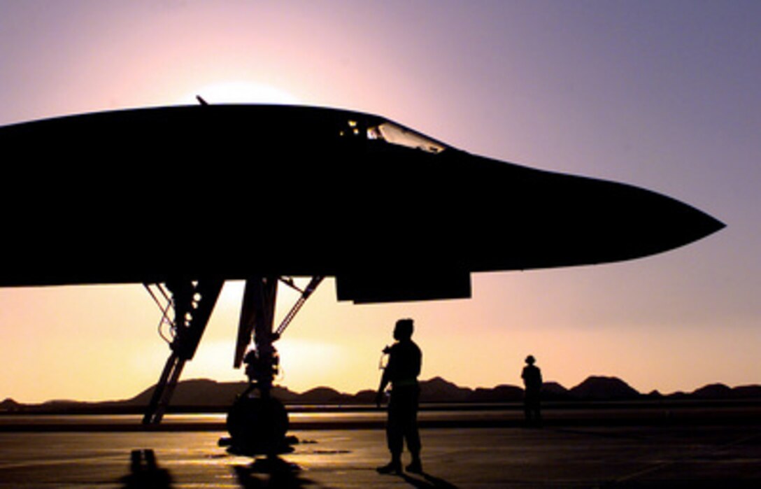 Two crew chiefs perform a pre-flight operations check with the crew of a U.S. Air Force B-1B Lancer bomber at an air base in the Persian Gulf region on Dec. 10, 1998. Lancer bombers, deployed to the region from Dyess Air Force Base, Texas, and Ellsworth Air Force Base, S.D., are multi-role, long range, heavy bombers. 