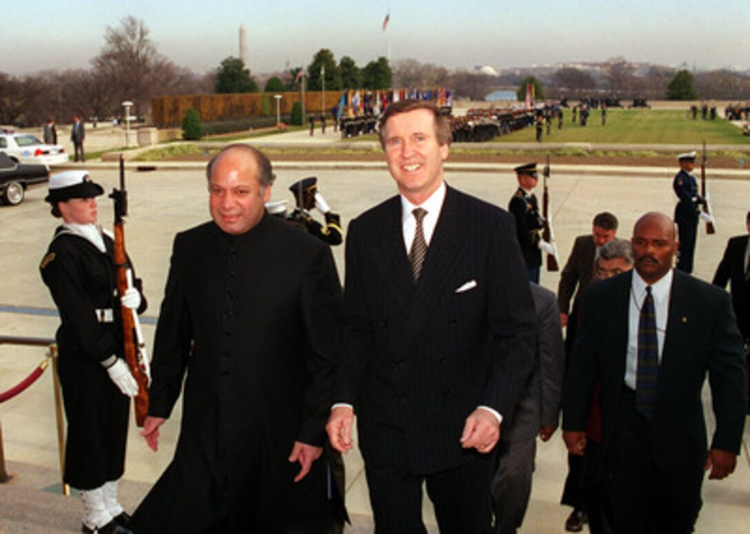 Secretary of Defense William S. Cohen (right) escorts visiting Prime Minister Nawaz Sharif, of Pakistan, into the Pentagon following the military full honors welcoming ceremony for Sharif on Dec. 3, 1998. Cohen and his senior advisors will meet with Sharif to discuss a range of regional and international issues of interest to both nations. 