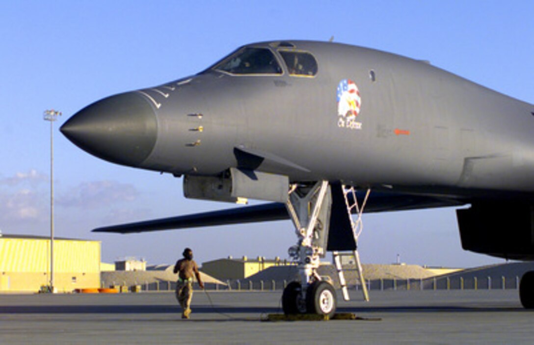 Crew Chief Senior Airman Mike Parks talks through his headset with the crew of a U.S. Air Force B-1B Lancer bomber as they go through the pre-flight checklist at an air base in the Persian Gulf region on Dec. 10, 1998. The Lancer, deployed from Dyess Air Force Base, Texas, is a multi-role, long range, heavy bomber. 