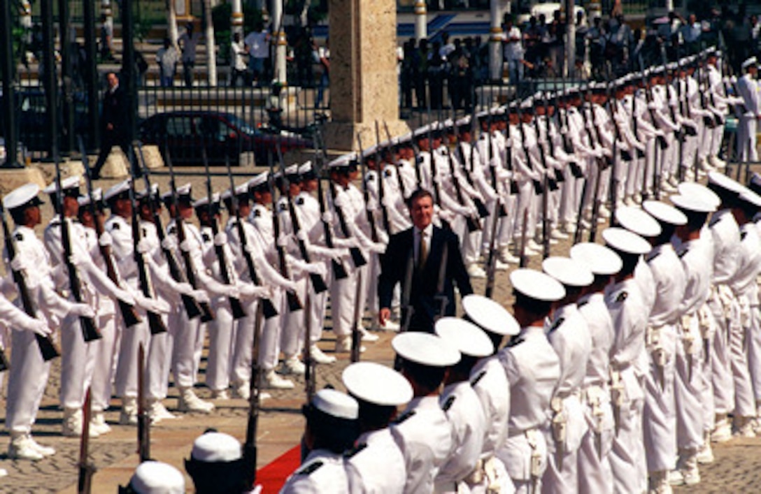 Secretary of Defense William S. Cohen passes through an armed forces honor cordon in Cartagena, Colombia, on Nov. 30, 1998. Cohen is in the Caribbean city to attend the Third Defense Ministerial of the Americas. 