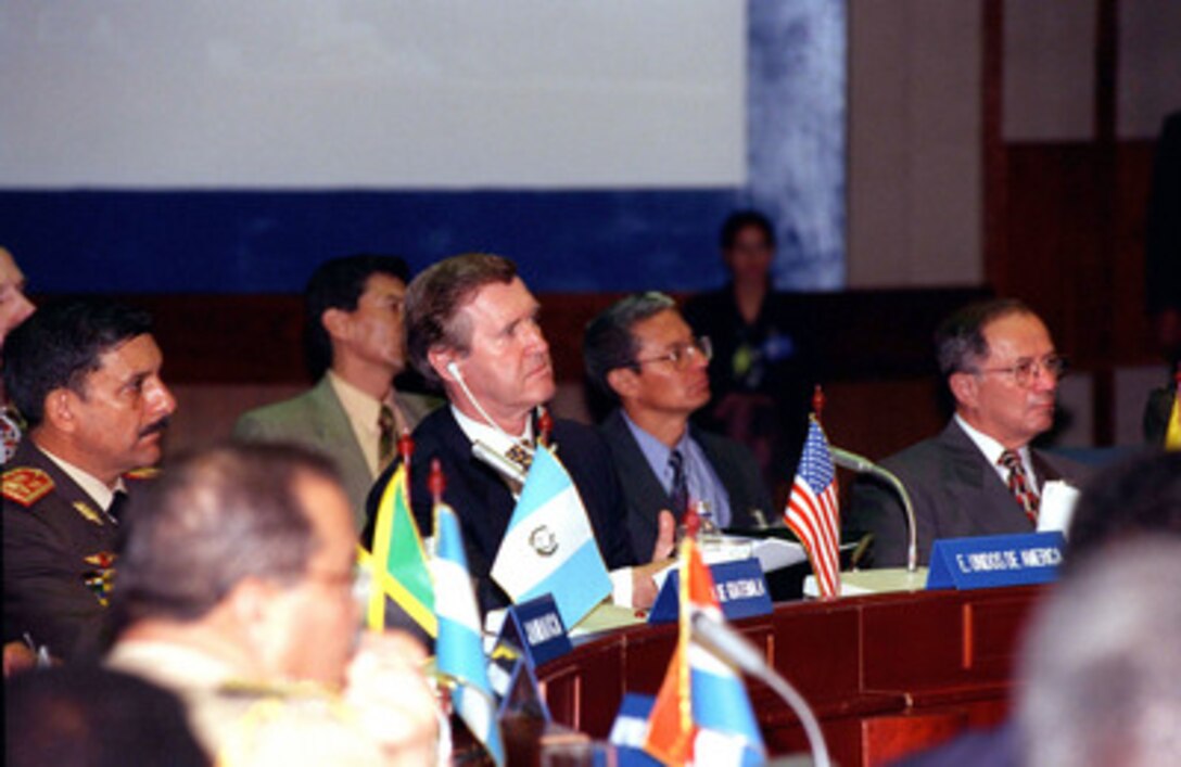 Secretary of Defense William S. Cohen (third from right) is seated among the other delegates as they listen to opening remarks by Colombian President Andres Pastrana at the Third Defense Ministerial of the Americas in Cartagena, Colombia, on Nov. 30, 1998. 