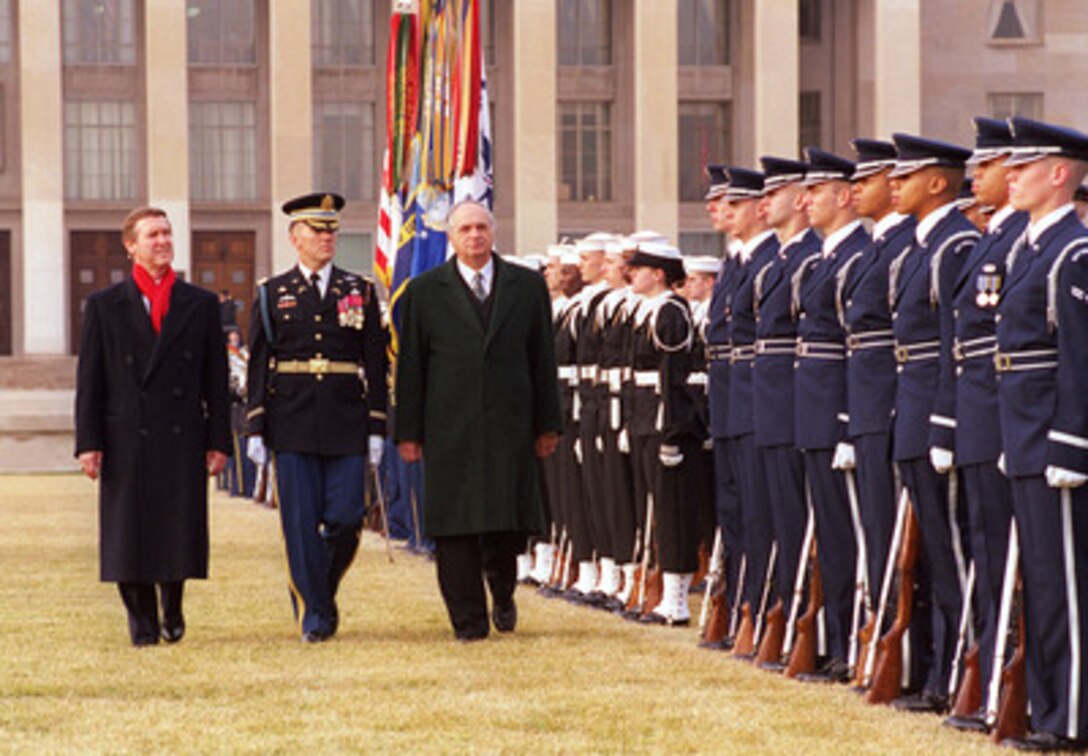 Secretary of Defense William S. Cohen (left) and Col. Gregory Gardner (center), U.S. Army, accompany Hungarian Minister of Defense Janos Szabo (right) as he inspects the honor guard during an armed forces full honor arrival ceremony in his honor at the Pentagon, Jan. 21, 1999. 