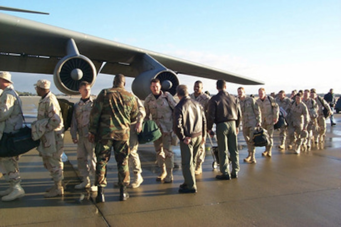 U.S. Air Force airmen from the 20th Component Repair Squadron board a C-141 Starlifter bound for Southwest Asia at Shaw Air Force Base, S.C., on Jan. 15, 1999. The airmen are deploying from Shaw in support of Operation Southern Watch, which is the U.S. and coalition enforcement of the no-fly-zone over Southern Iraq. 