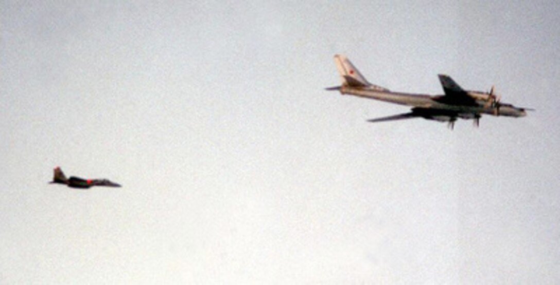 A U.S. Air Force F-15 Eagle escorts a Russian Tu-95 Bear H strategic bomber near Iceland on June 25, 1999. 