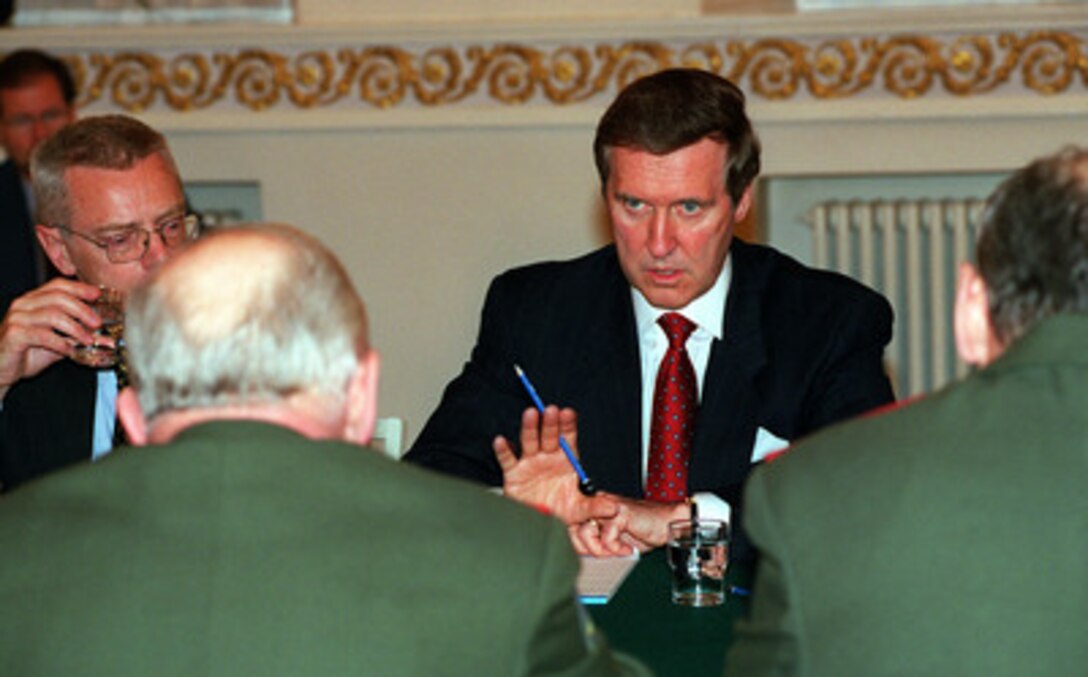 Secretary of Defense William S. Cohen (right) speaks to Russian Minister of Defense Marshal Igor Sergeyev (left foreground) during talks at the Presidential Place in Helsinki, Finland, on June 16, 1999. Cohen and Sergeyev are discussing the details of Russia's participation in the peacekeeping efforts in Kosovo. Under Secretary of Defense (Policy) Walter R. Slocombe (left) joined Cohen as part of the U.S. delegation. 