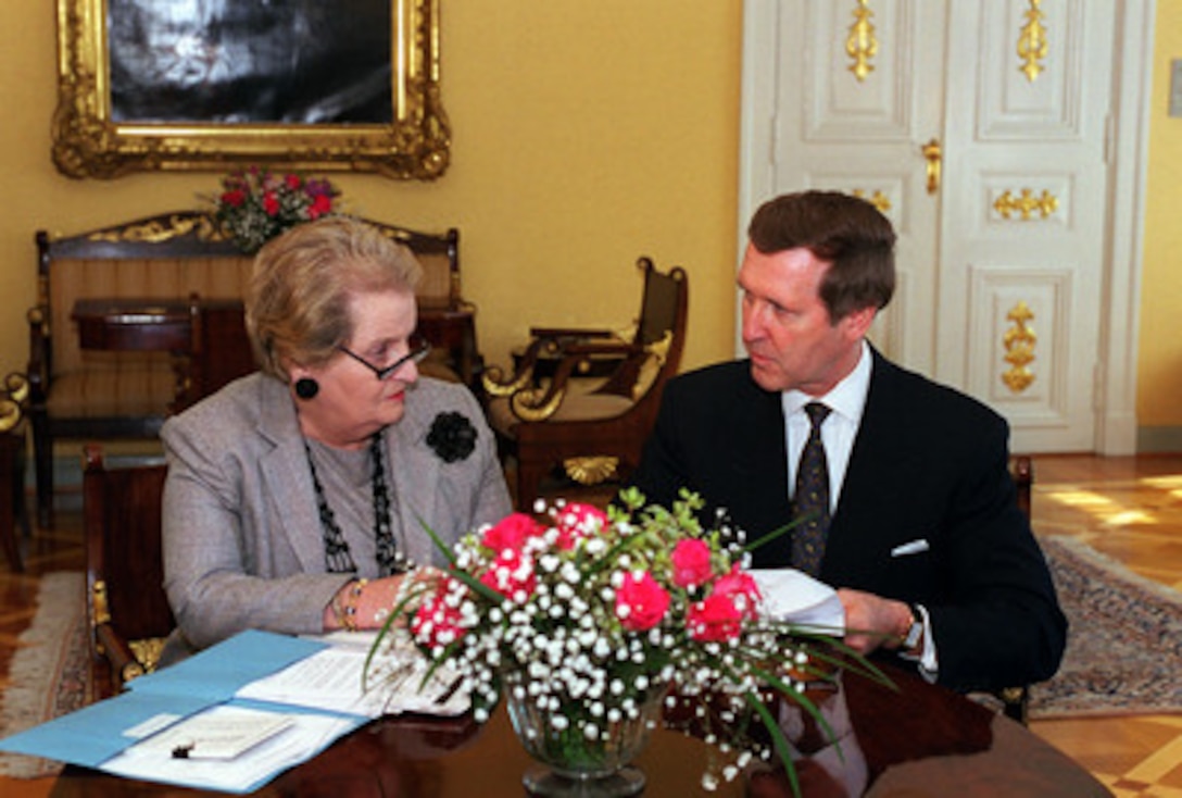 Secretary of State Madeleine Albright (left) and Secretary of Defense William S. Cohen discuss the progress of negotiations with the Russian delegation on details of Russia's participation in the peacekeeping efforts in Kosovo at the Presidential Place in Helsinki, Finland, on June 18, 1999. 