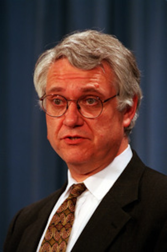 Deputy Secretary of Defense John J. Hamre answers a reporter's question at a July 8, 1999, Pentagon press briefing on the after action review process of the U.S. participation in NATO Operation Allied Force. Secretary of Defense William S. Cohen ordered the review to assess lessons learned from this operation. 