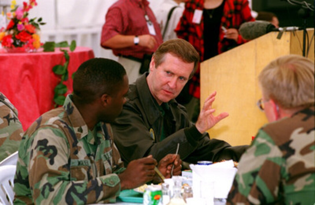 Secretary of Defense William S. Cohen (center) has lunch with the troops at Camp Able Sentry in Skopje, the Former Yugoslav Republic of Macedonia, on June 19, 1999. Cohen is visiting U.S. troops deploying for KFOR which is the NATO-led, international military force in Kosovo conducting the peacekeeping mission known as Operation Joint Guardian. 