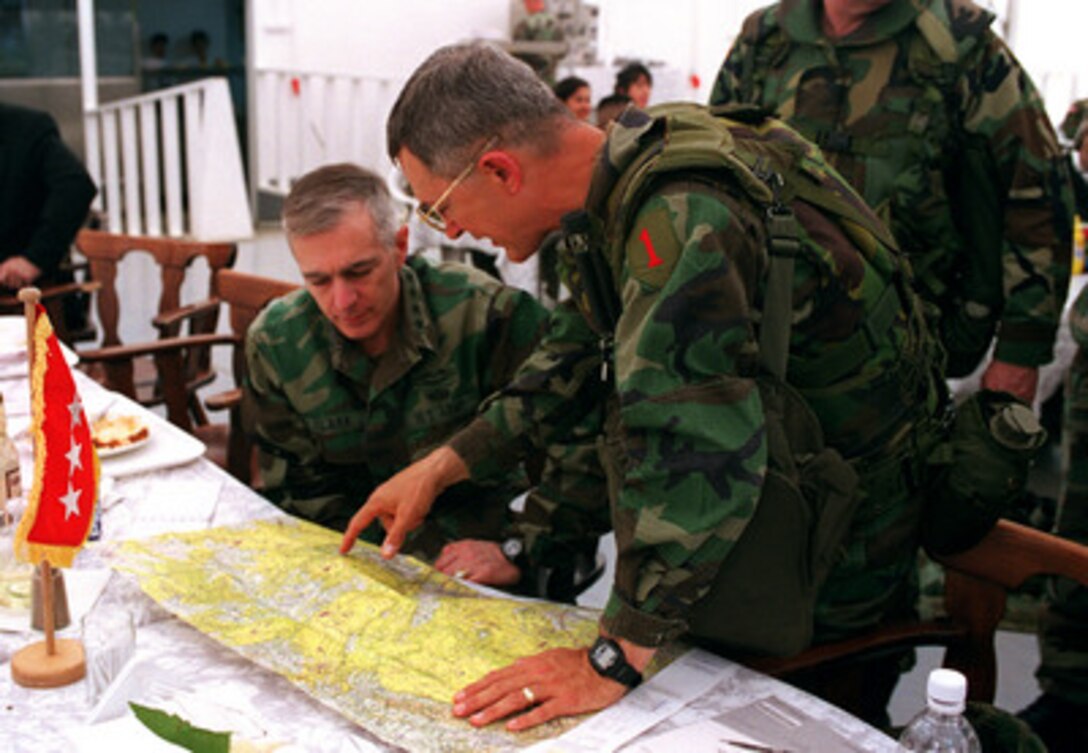 Lt. Gen. John W. Hendrix (right), U.S. Army, briefs Supreme Allied Commander Europe Gen. Wesley Clark (left) on the proposed helicopter route for Secretary of Defense William S. Cohen's visit to troops deployed to Kosovo for KFOR. KFOR is the NATO-led, international military force in Kosovo conducting the peacekeeping mission known as Operation Joint Guardian. Hendrix is the commanding general 5th Corps, U.S. Army. 