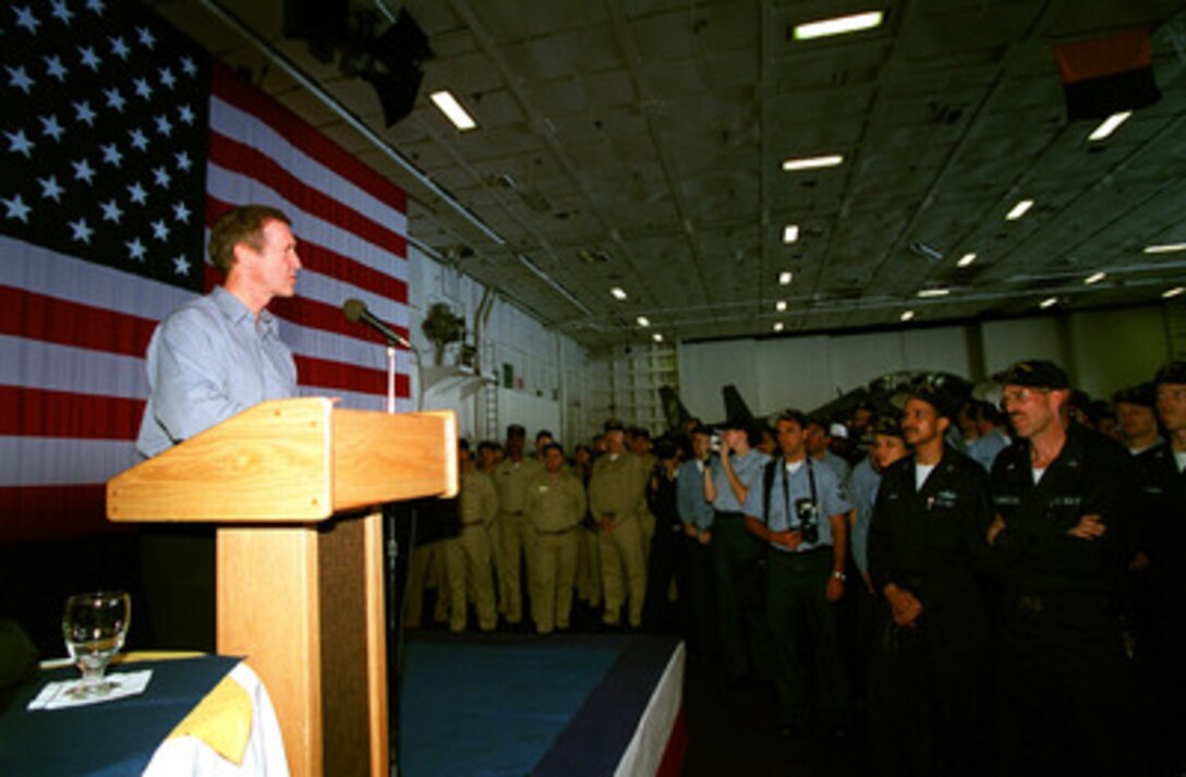 Secretary of Defense William S. Cohen speaks to the crew assembled in the hangar deck of the USS Theodore Roosevelt (CVN 71) as the aircraft carrier rides at anchor off Palma, Mallorca, on June 20, 1999. Cohen is visiting the ship to thank the crew for their efforts in NATO Operation Allied Force. 