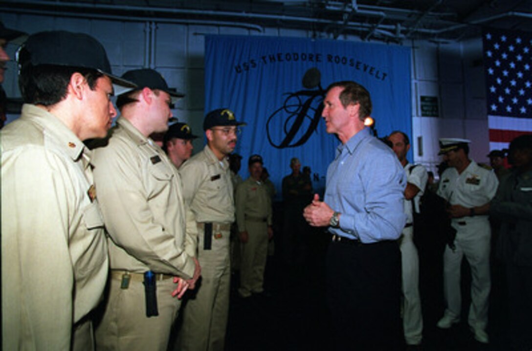 Secretary of Defense William S. Cohen talks with some of the officers of the USS Theodore Roosevelt (CVN 71) as the aircraft carrier rides at anchor off Palma, Mallorca, on June 20, 1999. Cohen is visiting the ship to thank the crew for their efforts in NATO Operation Allied Force. 
