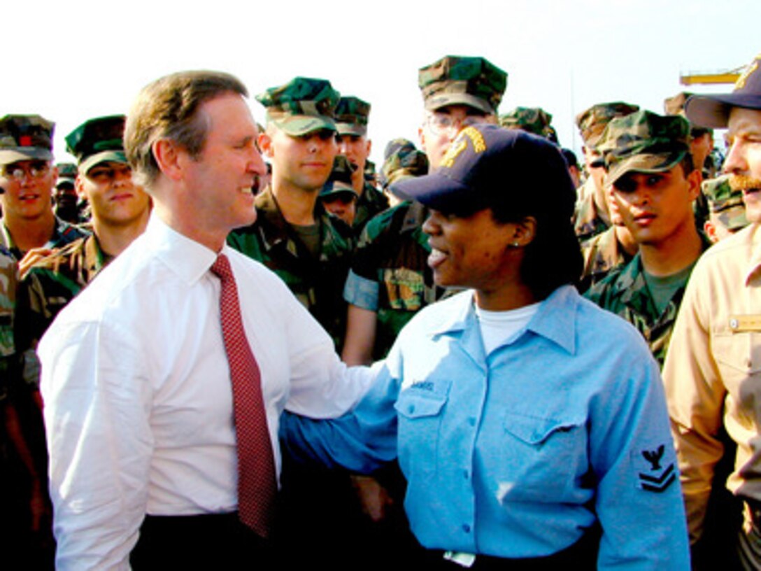 Secretary of Defense William S. Cohen (left) meets with Petty Officer 2nd Class Roshuni Samuel (right) before speaking to Marines of the 26th Marine Expeditionary Unit and sailors aboard the USS Kearsarge (LHD 3) on July 13, 1999, while the ship is in port at Thessoliniki, Greece. Cohen is visiting the Kearsarge to thank the Marines and crew who recently participated in NATO Operation Allied Force and Operation Joint Guardian. 