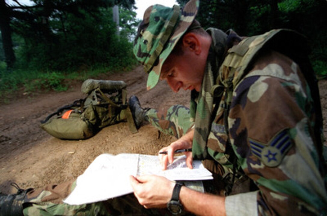 U.S. Air Force Senior Airman Edward W. Shulmanan locates the navigational points he will have to find in a 20 square kilometer area, during the land and compass navigation event of Tiger Challenge '99 at U.S. Army Camp Garry Owen, Republic of Korea, on July 6, 1999. Shulmanan is an enlisted terminal attack controller or ETAC from the 604th Air Support Operations Squadron, Republic of Korea. Tiger Challenge '99 is testing Shulmanan and 19 other competitors on their ability to perform a variety of tasks drawn directly from their mission of close air support, calling in air strikes against the enemy in close proximity to friendly forces. Shulmanan is from North Brunswick, N.J. 