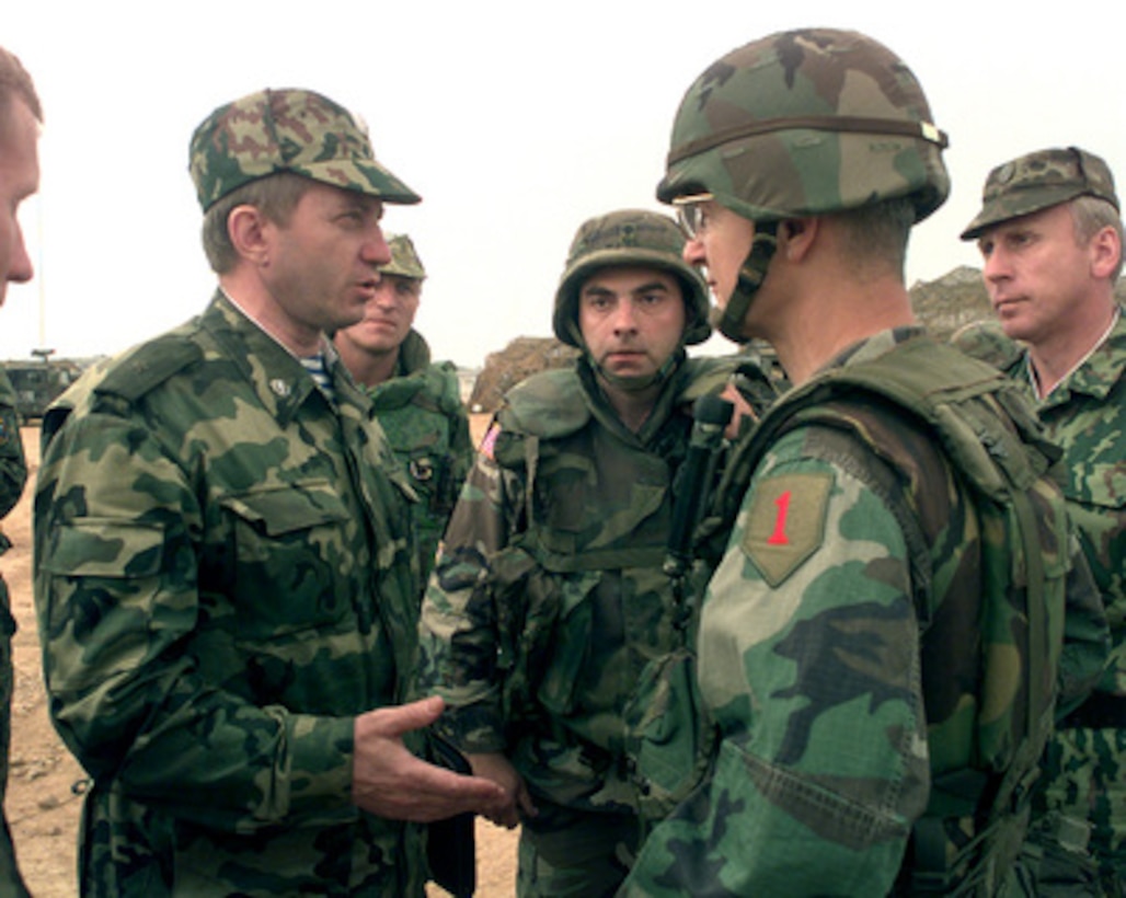 Maj. Gen. Valeri Evtoukovitich (left) commander of Russian Forces in Kosovo greets Brig. Gen. John Craddock (second from right), U.S. Army, commander of Task Force Falcon, at Camp Bondsteel, Kosovo, on July 7, 1999. Evtoukovitich and Craddock are meeting for the first time to discuss the relations between Russian and American forces in Kosovo as part of KFOR. KFOR is the NATO-led, international military force deployed to Kosovo on the peacekeeping mission known as Operation Joint Guardian. 