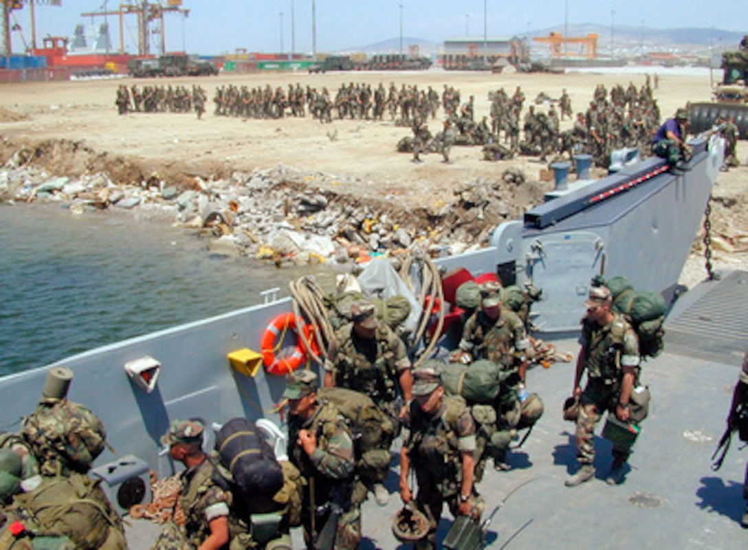 U.S. Marines from the 26th Marine Expeditionary Unit board a landing craft in Thessaloniki, Greece, on July 15, 1999, for return to the USS Kearsarge Amphibious Ready Group off shore. Elements of the 26th deployed into Kosovo as an enabling force for KFOR. KFOR is the NATO-led, international military force in Kosovo on the peacekeeping mission known as Operation Joint Guardian. 