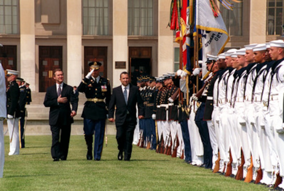 Israeli Prime Minister Ehud Barak (right) is escorted by Commander of Troops Col. Thomas M. Jordan (center), U.S. Army, and Secretary of Defense William S. Cohen (left) as Barak inspects the joint honor guard during an arrival ceremony at the Pentagon on July 16, 1999. Cohen and Barak will meet to discuss defense issues of interest to both nations. 