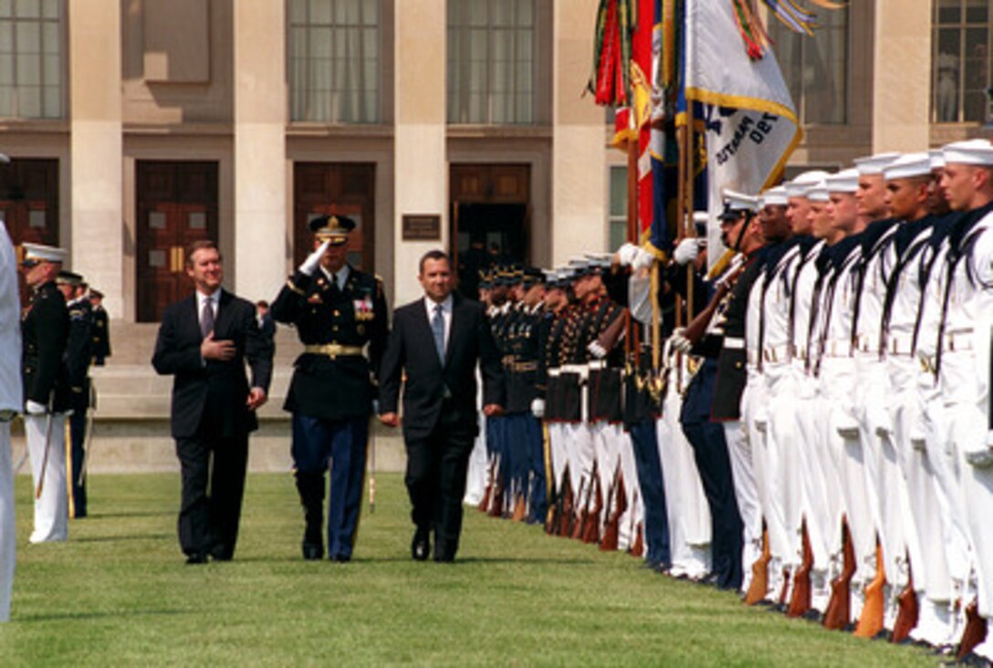 Israeli Prime Minister Ehud Barak (right) is escorted by Commander of Troops Col. Thomas M. Jordan (center), U.S. Army, and Secretary of Defense William S. Cohen (left) as Barak inspects the joint honor guard during an arrival ceremony at the Pentagon on July 16, 1999. Cohen and Barak will meet to discuss defense issues of interest to both nations. 