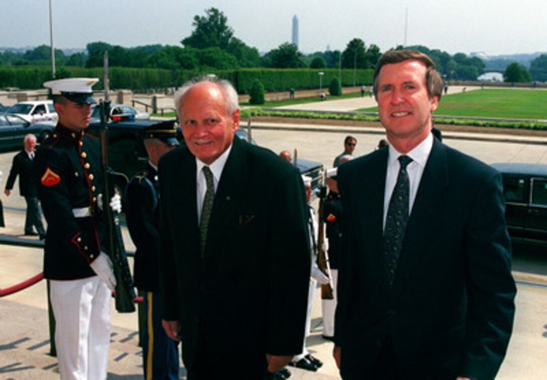 President Arpad Goncz (left), of Hungary, is escorted through an honor cordon into the Pentagon by Secretary of Defense William S. Cohen (right) on June 7, 1999. Goncz will meet with Cohen to discuss a range of issues relating to Hungary's membership in the NATO alliance. 