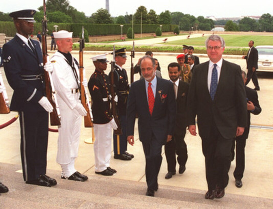 Deputy Secretary of Defense John J. Hamre (right) escorts Yusuf bin Alwai bin Abdallah, minister responsible for foreign affairs of the Sultanate of Oman, into the Pentagon, June 16, 1999. The two men will meet to discuss a range of issues of interest to both nations. 