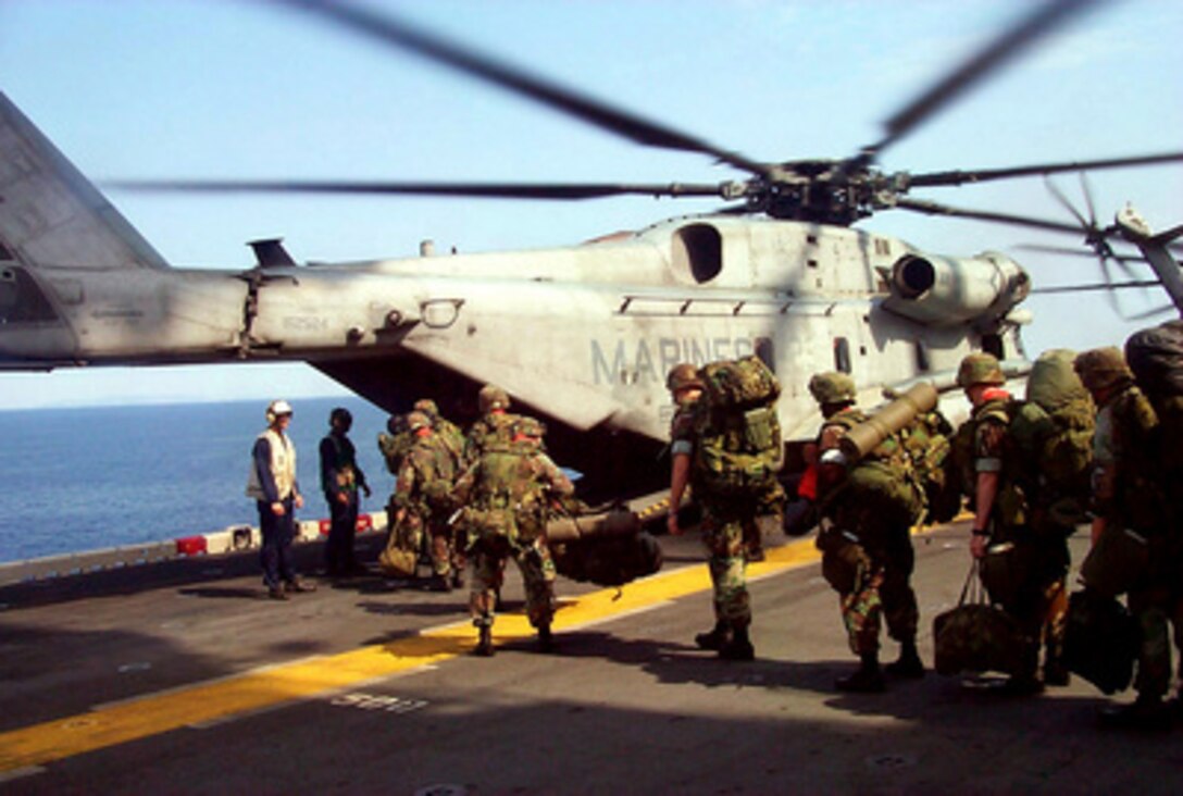 The first contingent of U.S. Marines from the 26th Marine Expeditionary Unit load on to a CH-53D Sea Stallion helicopter on the deck of the USS Kearsarge (LHD 3) as the ship operates in the Adriatic Sea on June 8, 1999. The Marines are headed to a staging area in Skopje, Macedonia, in support of NATO Operation Allied Force. 