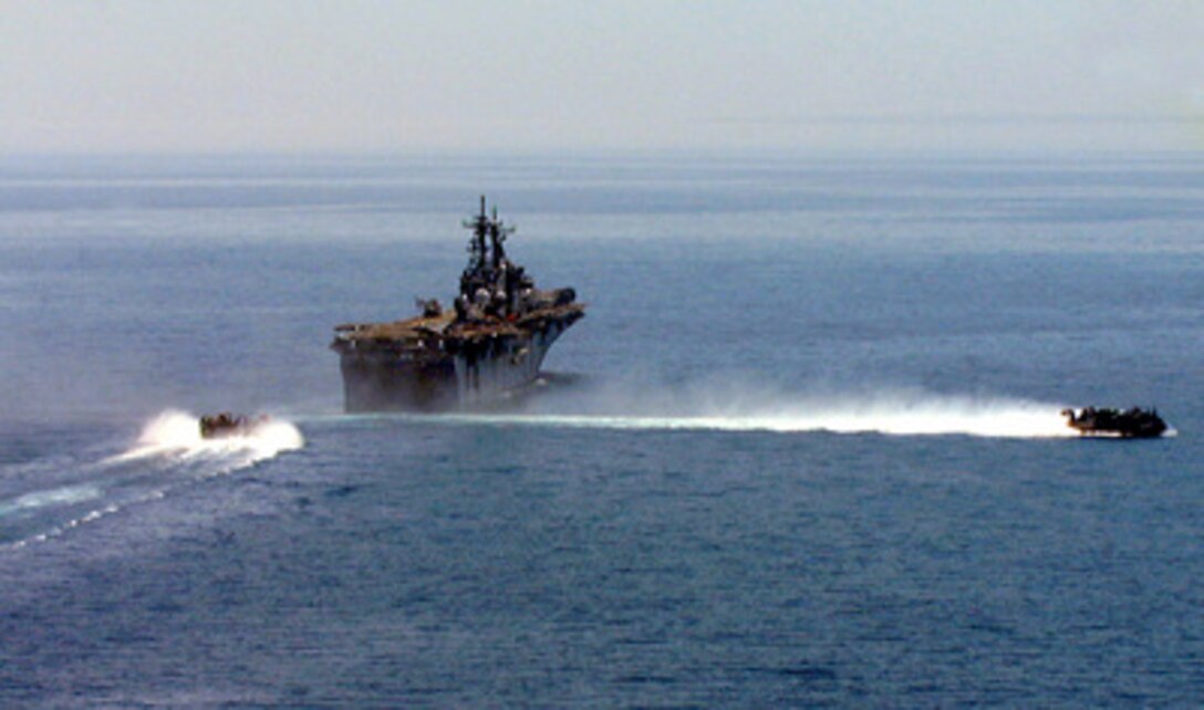 One U.S. Navy Landing Craft Air Cushioned (LCAC) leaves the well deck of the USS Kearsarge (LHD 3) as another approaches to pick up more personnel and equipment from the 26th Marine Expeditionary Unit and transport them to the beach at Litokhoron, Greece, on June 10, 1999. The USS Kearsarge Amphibious Ready Group is deployed in support of NATO Operation Allied Force. 