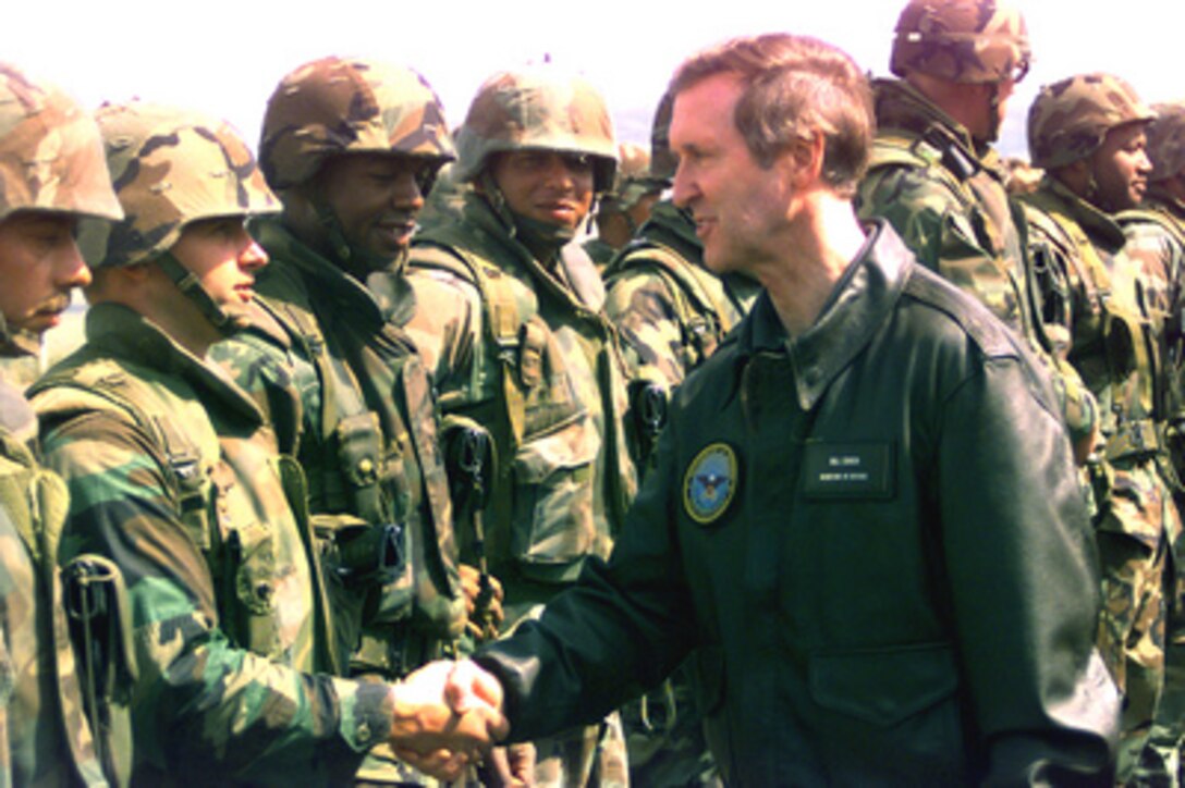 Secretary of Defense William S. Cohen (right) greets and thanks the U.S. Marines of the 26th Marine Expeditionary Unit at Camp Montief near Cernica, Kosovo, on June 19, 1999. Elements of the 26th deployed from ships of the USS Kearsarge Amphibious Ready Group as an enabling force for KFOR. KFOR is the NATO-led, international military force which will deploy into Kosovo on a peacekeeping mission known as Operation Joint Guardian. KFOR will ultimately consist of over 50,000 troops from more than 24 contributing nations, including NATO member-states, Partnership for Peace nations and others. 