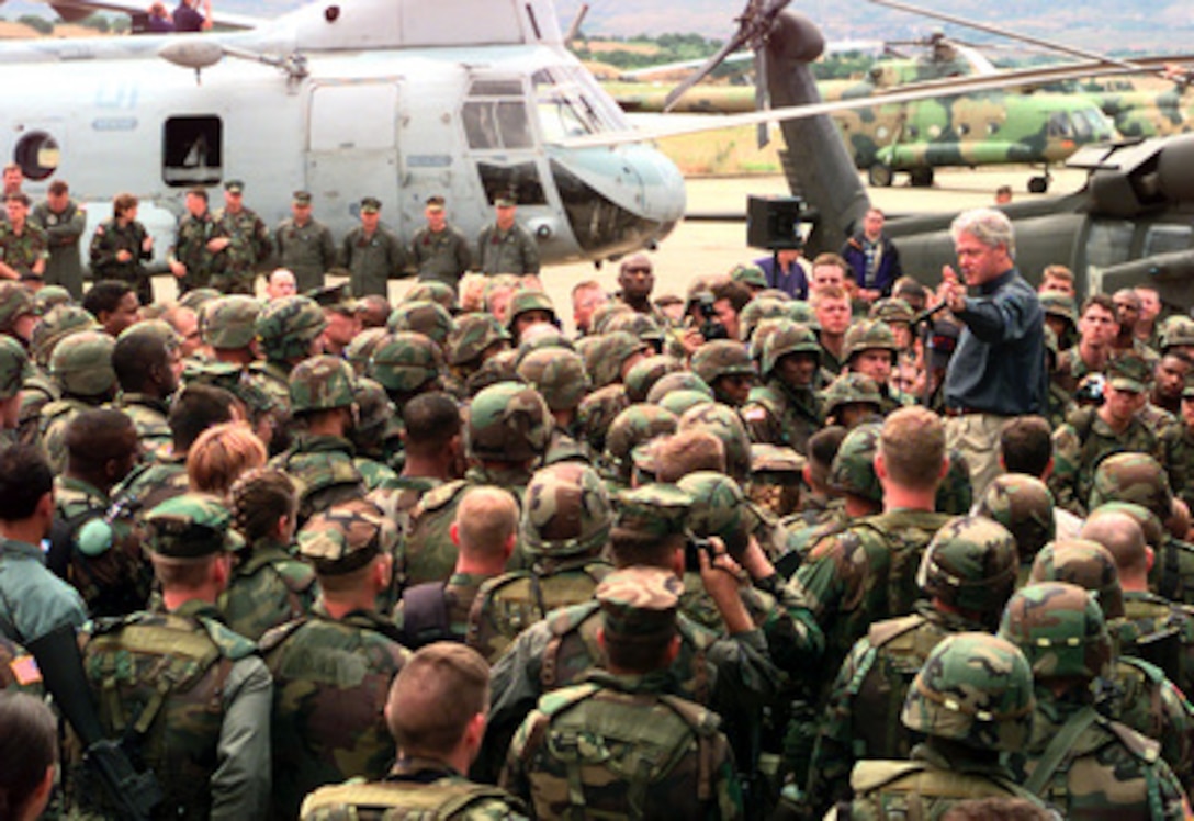 President Bill Clinton speaks to American, British, and French troops deployed to Skopje, Macedonia, on June 22, 1999. Many of the troops will become part of KFOR which is the NATO-led, international military force deploying into Kosovo on a peacekeeping mission known as Operation Joint Guardian. KFOR will ultimately consist of over 50,000 troops from more than 24 contributing nations, including NATO member-states, Partnership for Peace nations and others. The president is visiting troops and refugees as he stops in Macedonia and Aviano Air Base, Italy. 