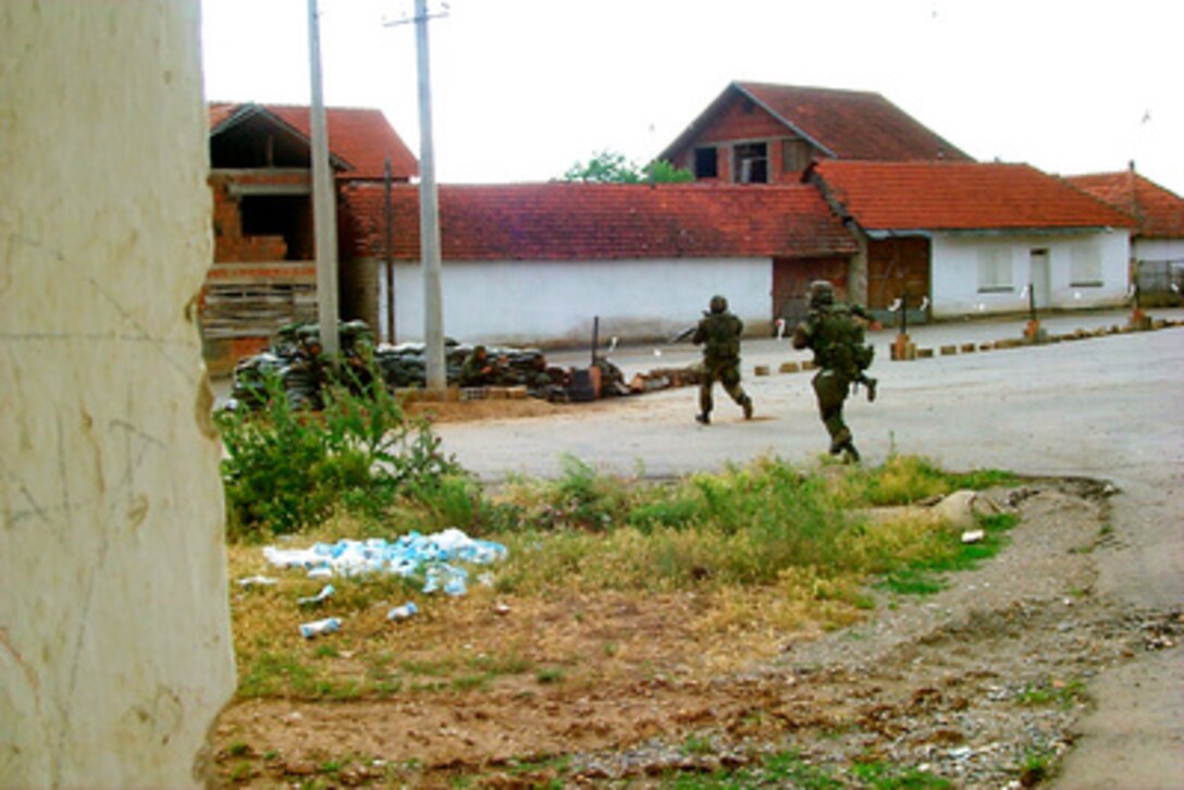 Marines of the 26th Marine Expeditionary Unit run to a bunker after their checkpoint came under fire from unknown snipers at a checkpoint in Zegra, Kosovo, on June 23, 1999. One of the attackers was killed and two others were wounded. No U.S. forces were injured in the exchange of fire. Elements of the 26th Marine Expeditionary Unit are deployed from ships of the USS Kearsarge Amphibious Ready Group as an enabling force for KFOR. KFOR is the NATO-led, international military force which will deploy into Kosovo on a peacekeeping mission known as Operation Joint Guardian. 
