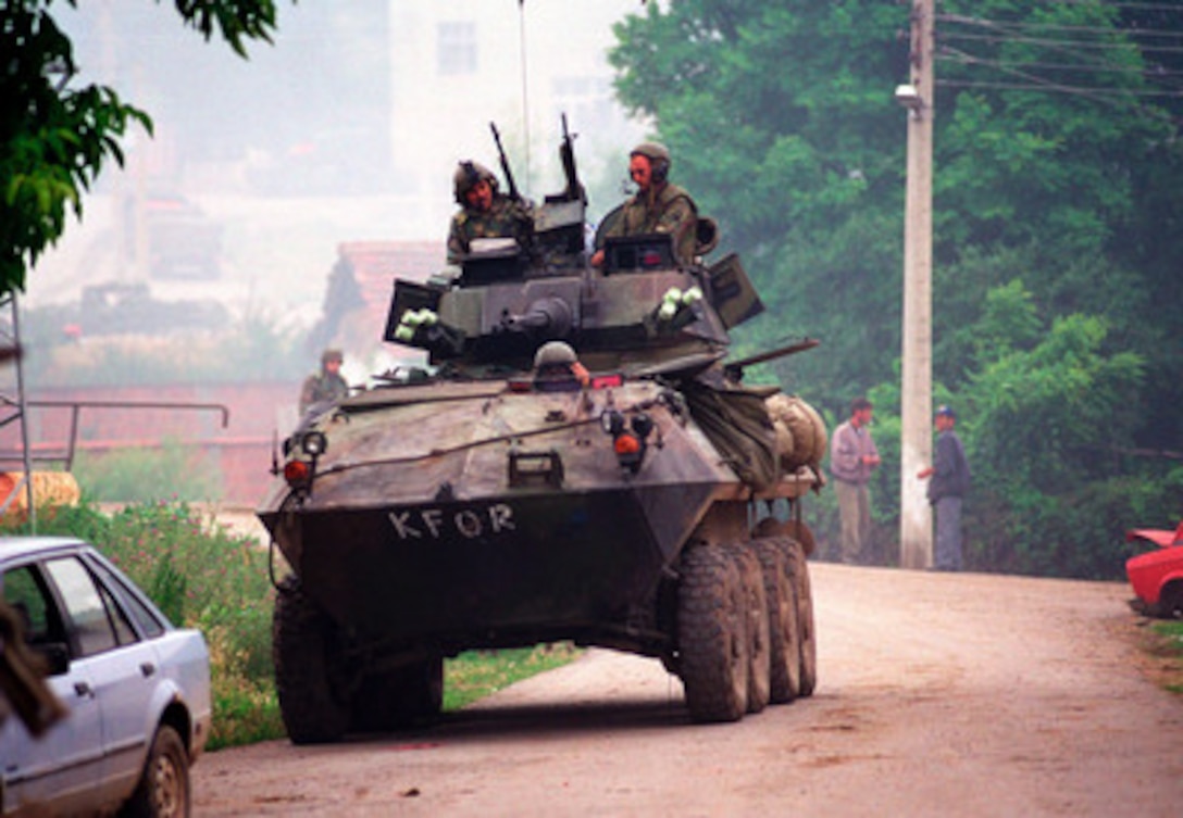 A U.S. Marine Corps Light Armored Vehicle (LAV-25) from the 2nd Light Armored Reconnaissance Battalion patrols in the village of Zegra, Kosovo, on June 27, 1999. Elements of the 26th Marine Expeditionary Unit are deployed from ships of the USS Kearsarge Amphibious Ready Group as an enabling force for KFOR. KFOR is the NATO-led, international military force which will deploy into Kosovo on a peacekeeping mission known as Operation Joint Guardian. KFOR will ultimately consist of over 50,000 troops from more than 24 contributing nations, including NATO member-states, Partnership for Peace nations and others. 