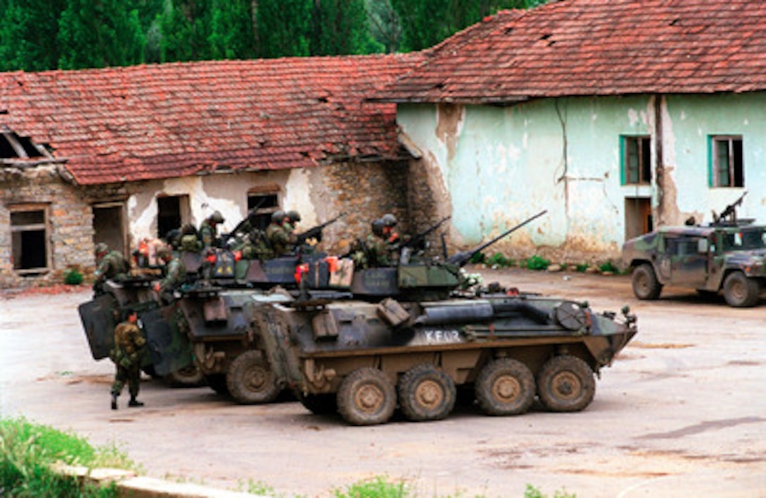 Marines from the 2nd Light Armored Reconnaissance Battalion prepare for an urban patrol aboard their Light Armored Vehicles (LAV-25) in the village of Zegra, Kosovo, on June 27, 1999. Elements of the 26th Marine Expeditionary Unit are deployed from ships of the USS Kearsarge Amphibious Ready Group as an enabling force for KFOR. KFOR is the NATO-led, international military force which will deploy into Kosovo on a peacekeeping mission known as Operation Joint Guardian. KFOR will ultimately consist of over 50,000 troops from more than 24 contributing nations, including NATO member-states, Partnership for Peace nations and others. 