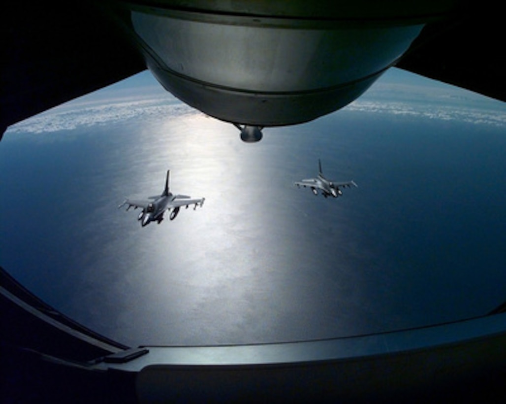 Two U.S. Air Force F-16 Fighting Falcons are framed by the boom operator's window as they move into position to take on fuel behind a KC-135 Stratotanker over the Mediterranean Sea on Feb. 26, 1999. U.S. aircraft and support personnel are deployed to their forward staging bases in Europe for potential NATO air operations. The Fighting Falcons are from the 555th Fighter Squadron, while the Stratotanker is flown by the 186th Air Refueling Wing, Meridian, Miss. All three aircraft are operating from Aviano Air Base, Italy. 