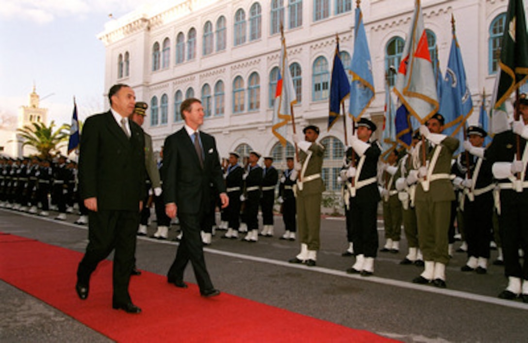 Republic of Tunisia Minister of National Defense Habib Ben Yahia (left) escorts Secretary of Defense William S. Cohen (right) during an armed forces full honors welcoming ceremony at the Ministry of Defense in Tunis on Feb. 8, 1999. 
