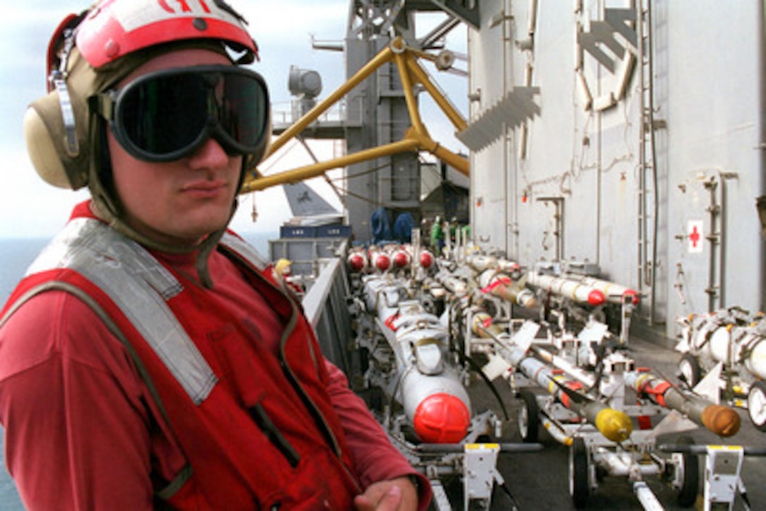 Petty Officer 2nd Class Ricardo Salicrup stands watch over a variety of missiles and bombs in the area known as the bomb farm on the flight deck of the USS Carl Vinson (CVN-70) on Feb. 27, 1999. Vinson and its embarked Carrier Air Wing 11 are on station in the Persian Gulf in support of Operation Southern Watch, which is the U.S. and coalition enforcement of the no-fly-zone over Southern Iraq. Salicrup is a Navy Aviation Ordnanceman from Santurce, Puerto Rico. 