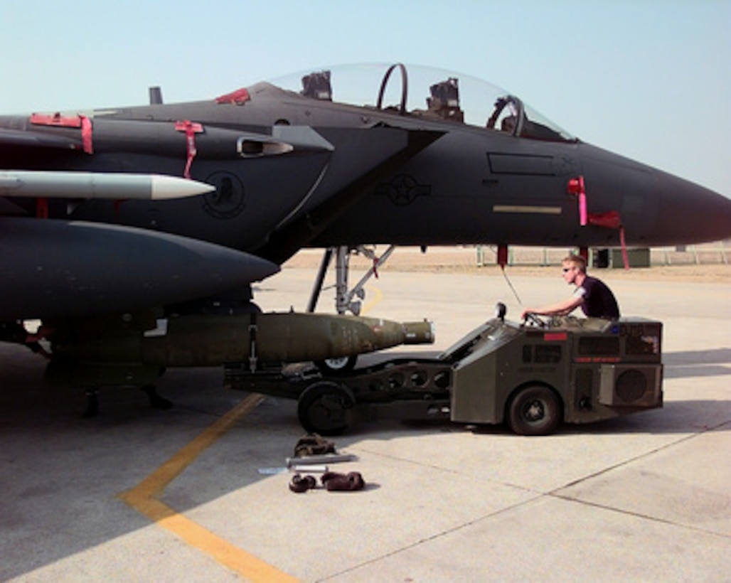 U.S. Air Force Airman Kevin Hart attaches a GBU-24 laser guided bomb to an F-15 Eagle at Aviano Air Base, Italy, on March 24, 1999. The Eagle is being prepared for air strike missions in support of NATO Operation Allied Force. Operation Allied Force is the air operation against targets in the Federal Republic of Yugoslavia. The Eagle and its crew are deployed to Aviano from the 494th Fighter Squadron, RAF Lakenheath, United Kingdom. 