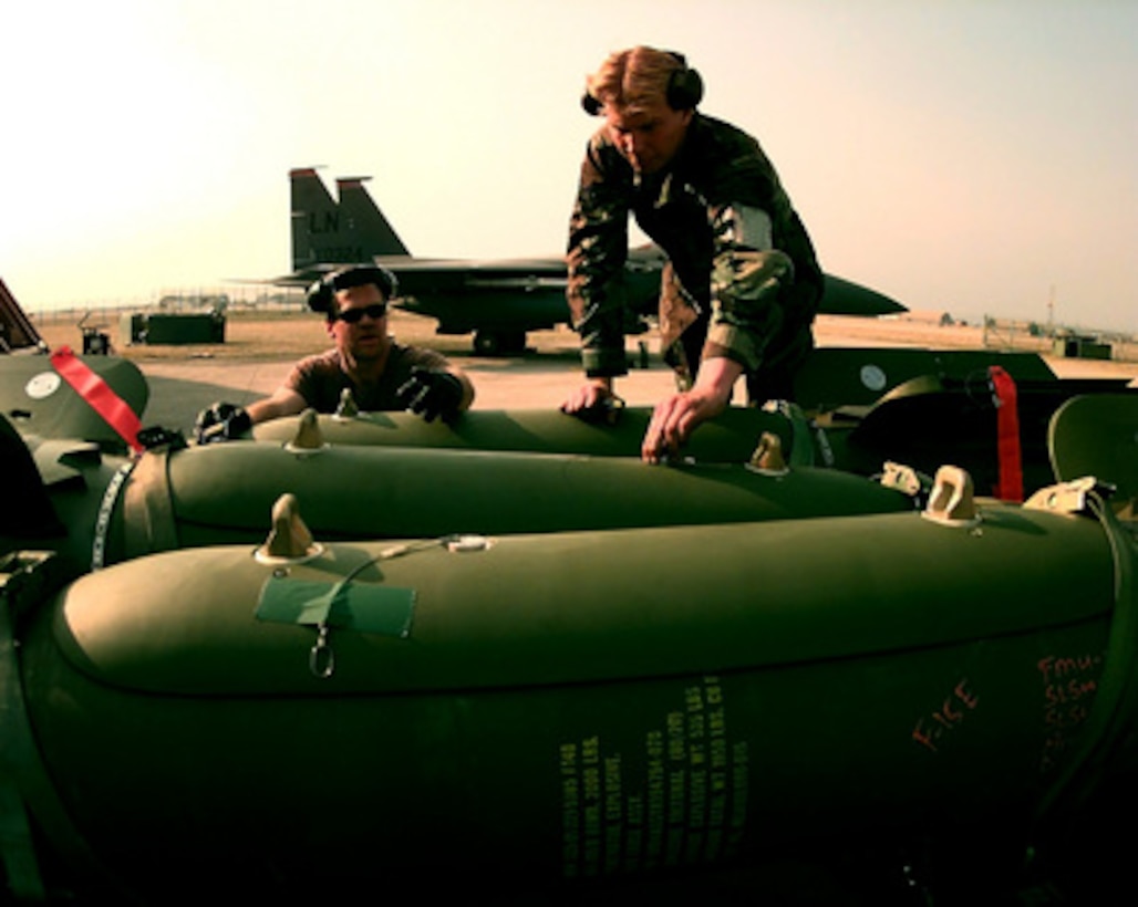 Staff Sgt. Barry Muller (left) and Airman Joseph Sirek prepare to attach a GBU-24 laser guided bomb to an F-15 Eagle at Aviano Air Base, Italy, on March 24, 1999. The Eagle is being prepared for air strike missions in support of NATO Operation Allied Force. Operation Allied Force is the air operation against targets in the Federal Republic of Yugoslavia. The Eagle and its crew are deployed to Aviano from the 494th Fighter Squadron, RAF Lakenheath, United Kingdom. 