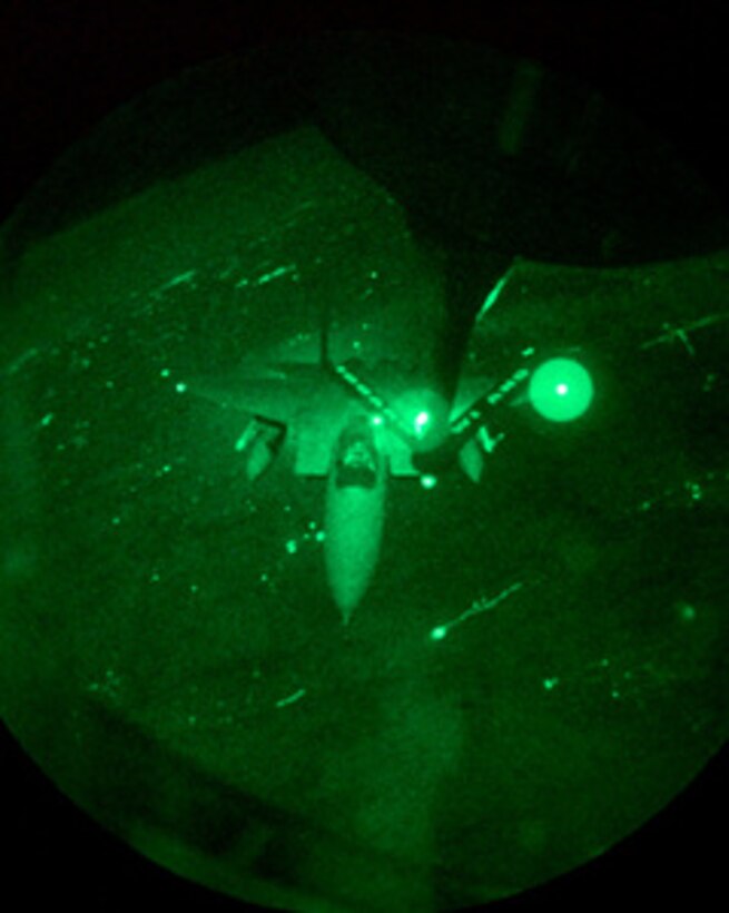 A U.S. Air Force F-15 Eagle glows green in this night vision photograph as it refuels from a KC-135 Stratotanker during air strike missions in support of NATO Operation Allied Force on March 25, 1999. Operation Allied Force is the air operation against targets in the Federal Republic of Yugoslavia. The Eagle is deployed to Aviano from the 493rd Fighter Squadron, RAF Lakenheath, United Kingdom. The Stratotanker is deployed from the 128th Air Refueling Wing, Milwaukee, Wis. 