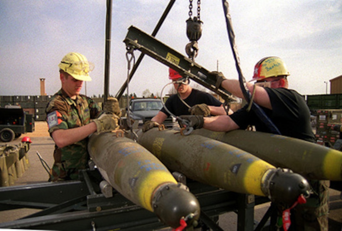 Armament personnel for the 31st Air Expeditionary Wing load bombs on a transport trailer at Aviano Air Base, Italy, on March 29, 1999, during NATO Operation Allied Force. Operation Allied Force is the air operation against targets in the Federal Republic of Yugoslavia. 