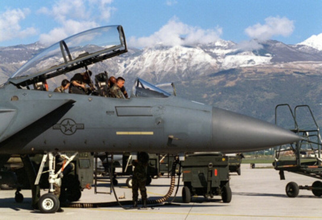 Senior Airman August Christopher, Sgt. Berry Bugle and Staff Sgt. Ron Manneque perform video checks on an F-15E Strike Eagle at Aviano Air Base, Italy, as the aircraft is prepared for an air strike mission in support of NATO Operation Allied Force on April 20, 1999. Operation Allied Force is the air operation against targets in the Federal Republic of Yugoslavia. 