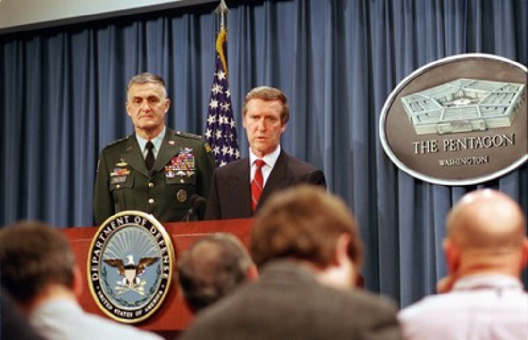 Secretary of Defense William S. Cohen (right) answers a reporter's question during a Pentagon press briefing with Chairman of the Joint Chiefs of Staff Gen. Henry H. Shelton (left), U.S. Army, on NATO Operation Allied Force on April 29, 1999. Operation Allied Force is the air operation against targets in the Federal Republic of Yugoslavia. 