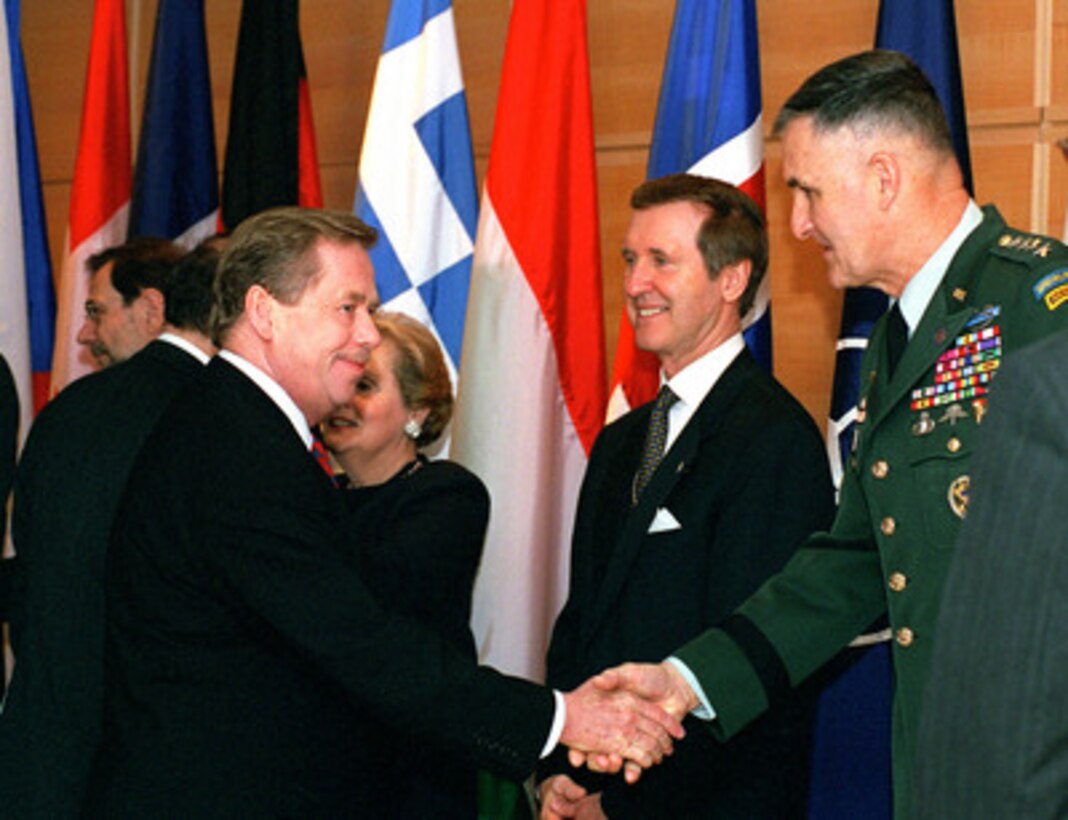 President Vaclav Havel (left), of the Czech Republic, is greeted as a new member of NATO by the Chairman of the Joint Chiefs of Staff General Henry H. Shelton (right), U.S. Army, as he arrives for the North Atlantic Council meeting. The U.S. hosted NATO Summit meetings were held April 23-25, 1999 in Washington, D.C. 