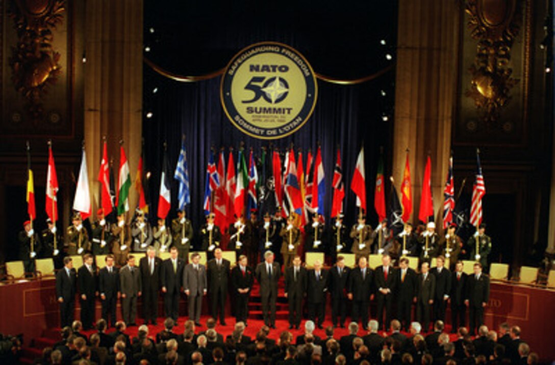 Representatives of the 19-member NATO nations stand for a group photograph during the commemorative ceremony of the 50th anniversary of NATO held at the Andrew W. Mellon Auditorium, Washington, D.C., on April 23, 1999. 