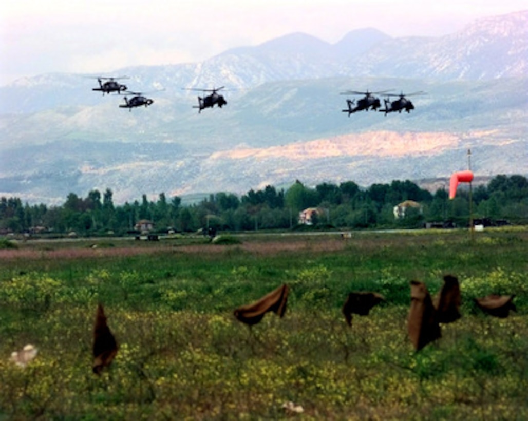 A second wave of U.S. Army UH-60 Blackhawk and AH-64A Apache attack helicopters from Task Force Hawk comes in for a landing at Rinas Airport in Tiranë, Albania, on April 25, 1999. The Task Force Hawk helicopters are deploying to Tiranë in support of NATO Operation Allied Force. Operation Allied Force is the air operation against targets in the Federal Republic of Yugoslavia. 